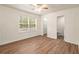 Bright bedroom with ceiling fan, wood-look floors and access to bathroom at 261 Quail Run, Roswell, GA 30076