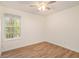 Spacious bedroom featuring wood-look floors and a window at 261 Quail Run, Roswell, GA 30076
