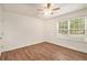 Spacious bedroom with large windows, wood-look floors and ceiling fan at 261 Quail Run, Roswell, GA 30076