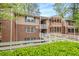 Condo building with a wooden walkway and green landscaping at 261 Quail Run, Roswell, GA 30076