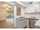 Updated kitchen with white cabinets, stainless steel appliances, and light countertops at 261 Quail Run, Roswell, GA 30076