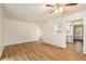 Living room with wood-look floors, ceiling fan, and access to patio at 261 Quail Run, Roswell, GA 30076