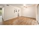 Spacious living room with wood-look flooring and access to private patio at 261 Quail Run, Roswell, GA 30076