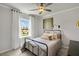 Cozy bedroom with natural light, decorative curtains, and modern ceiling fan at 392 Village Ln, Fairburn, GA 30213