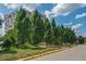 Green trees line a pathway leading to a complex with views and available scooters for transport at 587 Virginia Ave # 805, Atlanta, GA 30306