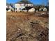 The back of an unfinished home with visible windows sits on a large lot in a neighborhood under construction at 3030 Fairway Dr, Villa Rica, GA 30180