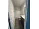 Standard bathroom featuring a shower-tub combo with gray wood-look floors and a gray vanity cabinet at 3030 Fairway Dr, Villa Rica, GA 30180