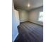 Cozy bedroom with neutral walls and plush carpeting, lit by a single window at 3030 Fairway Dr, Villa Rica, GA 30180