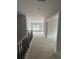 This upstairs hallway features an iron staircase and several doors leading to bedrooms and other rooms on the second level at 3030 Fairway Dr, Villa Rica, GA 30180