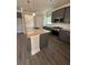 Modern kitchen with granite countertops, stainless steel appliances, and wood flooring at 3030 Fairway Dr, Villa Rica, GA 30180