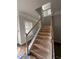 A stairway with natural wood banister and black wrought iron spindles at 3030 Fairway Dr, Villa Rica, GA 30180