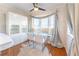 Bright dining room with a glass table, seating area, and hardwood floors at 111 Swanton Hill Ct, Decatur, GA 30030