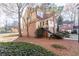 View of a charming brick and siding home on a landscaped lot with mature trees at 111 Swanton Hill Ct, Decatur, GA 30030