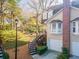 A cozy home with a beautiful brick chimney, complemented by lush trees and a winding staircase at 111 Swanton Hill Ct, Decatur, GA 30030