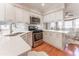 Bright kitchen with white cabinets, quartz countertops, stainless appliances, and hardwood flooring at 111 Swanton Hill Ct, Decatur, GA 30030