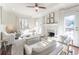 Bright living room featuring a fireplace, ceiling fan, and French doors leading to an outdoor space at 111 Swanton Hill Ct, Decatur, GA 30030