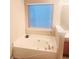 Bathroom featuring a relaxing bathtub and window at 1107 Silverbrooke Dr, Powder Springs, GA 30127