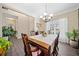 Bright dining room featuring a wood table, chandelier, and hardwood floors at 1107 Silverbrooke Dr, Powder Springs, GA 30127