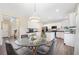 Modern kitchen with white cabinets, an island, and a glass dining table at 1107 Silverbrooke Dr, Powder Springs, GA 30127