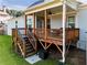 Inviting back porch with ceiling fan and wood railing at 1927 Streamlet Xing, Kennesaw, GA 30152