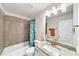 Bright bathroom featuring granite vanity, tile shower, and ceramic tile flooring at 1927 Streamlet Xing, Kennesaw, GA 30152