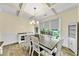 Elegant dining room with coffered ceiling, wainscoting, large window and wood floors at 1927 Streamlet Xing, Kennesaw, GA 30152