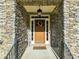 Charming front door with stone facade, wreath, and 'Welcome' sign at 1927 Streamlet Xing, Kennesaw, GA 30152