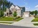 Beautiful two-story home with a brick and stone facade, a well-manicured lawn, and an attached garage at 1927 Streamlet Xing, Kennesaw, GA 30152