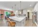 Open concept kitchen with white cabinets, stainless steel appliances, large island and adjacent dining area at 1927 Streamlet Xing, Kennesaw, GA 30152