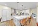 Bright kitchen boasts an island with a white countertop, pendant lighting, and stainless steel appliances at 1927 Streamlet Xing, Kennesaw, GA 30152