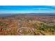 Aerial view of a secluded cabin surrounded by vibrant fall foliage, highlighting privacy at 49 Holly Springs Ne Rd, White, GA 30184