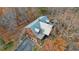Aerial view of a cabin nestled among trees, with a metal roof and surrounding landscape at 49 Holly Springs Ne Rd, White, GA 30184