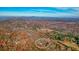 Scenic aerial view of a charming home secluded within a colorful autumn forest at 49 Holly Springs Ne Rd, White, GA 30184