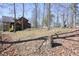Spacious backyard with mature trees and sparse ground cover creating a natural, peaceful environment at 49 Holly Springs Ne Rd, White, GA 30184