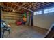Unfinished basement with roll up door and lawn equipment storage offering great potential for parking and storage at 49 Holly Springs Ne Rd, White, GA 30184