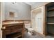 Rustic bathroom with wood-paneled vanity, mirror, toilet, and a stand-up shower with shelving at 49 Holly Springs Ne Rd, White, GA 30184