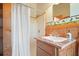 Bathroom featuring a walk-in shower, single vanity, wood accents, and decorative wallpaper border at 49 Holly Springs Ne Rd, White, GA 30184