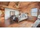 Bedroom featuring wood paneled walls, hardwood floors and a seating area at 49 Holly Springs Ne Rd, White, GA 30184
