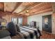 Bedroom featuring wood walls, hardwood floors, a ceiling fan and outdoor views at 49 Holly Springs Ne Rd, White, GA 30184