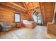 Bedroom with wood walls, wood floors, a bed with built in drawers, and natural light at 49 Holly Springs Ne Rd, White, GA 30184