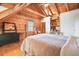 Bright bedroom featuring wood paneled walls, a ceiling fan and built in shelving at 49 Holly Springs Ne Rd, White, GA 30184