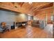 Bonus room featuring wood floors, wood walls, vaulted ceiling, a work area, and comfortable seating at 49 Holly Springs Ne Rd, White, GA 30184