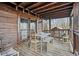 Wooden deck with rustic table set and seating offers a cozy space for outdoor dining and relaxation at 49 Holly Springs Ne Rd, White, GA 30184