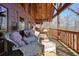 Outdoor deck features wicker furniture, creating a cozy and inviting space to enjoy the view at 49 Holly Springs Ne Rd, White, GA 30184