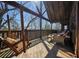 Inviting covered deck with swinging chairs, outdoor seating, and natural wood finishes for relaxing in the fresh air at 49 Holly Springs Ne Rd, White, GA 30184