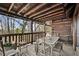 Open deck area with rustic table set perfect for al fresco dining and relaxing with a view at 49 Holly Springs Ne Rd, White, GA 30184
