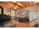 Rustic dining area featuring hardwood floors, wood walls and ceilings, and a wood burning stove at 49 Holly Springs Ne Rd, White, GA 30184