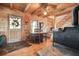 Rustic dining area featuring hardwood floors and ceilings and wood burning stove at 49 Holly Springs Ne Rd, White, GA 30184