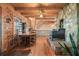 Rustic dining area with hardwood floors and ceilings, a black fireplace, and wood table at 49 Holly Springs Ne Rd, White, GA 30184