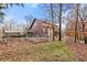 Quaint fenced property with a cozy cabin featuring a classic log siding, nestled among natural surroundings at 49 Holly Springs Ne Rd, White, GA 30184